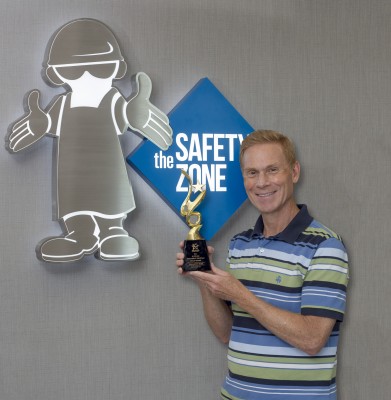 Jeff Ignatuk displays The Safety Zone's gold award from The United Group